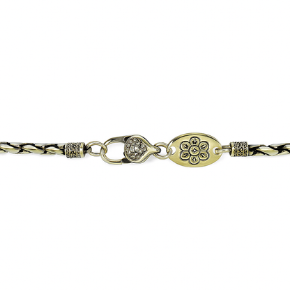 Bracelet with braided design and gold clasp on a white background