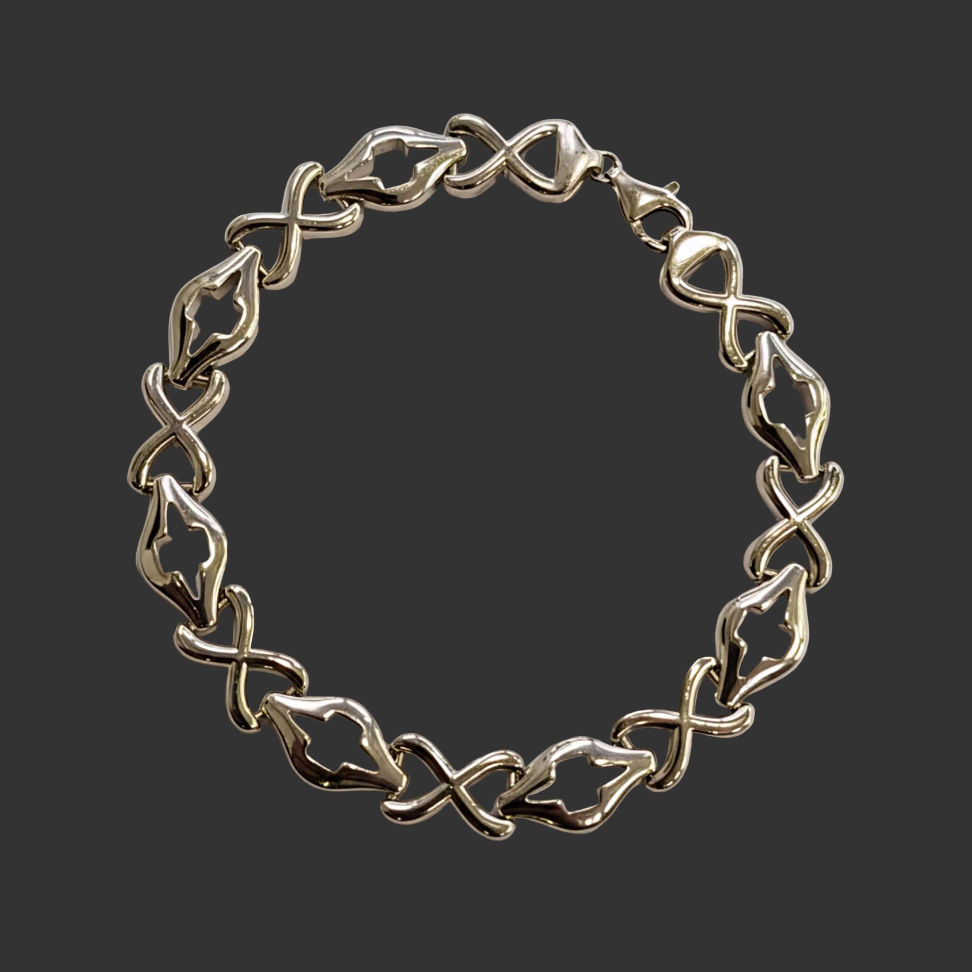 Silver bracelet on a light gray background