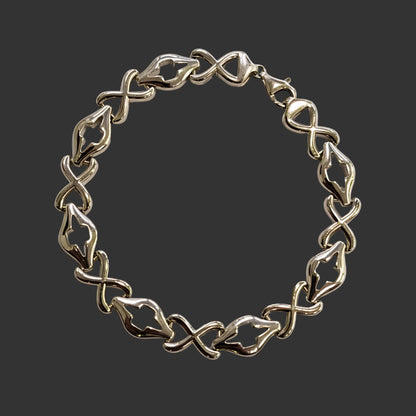 Silver bracelet on a light gray background