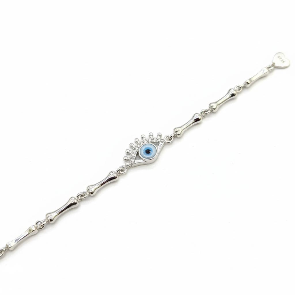 Silver bracelet with a blue eye charm on a white background