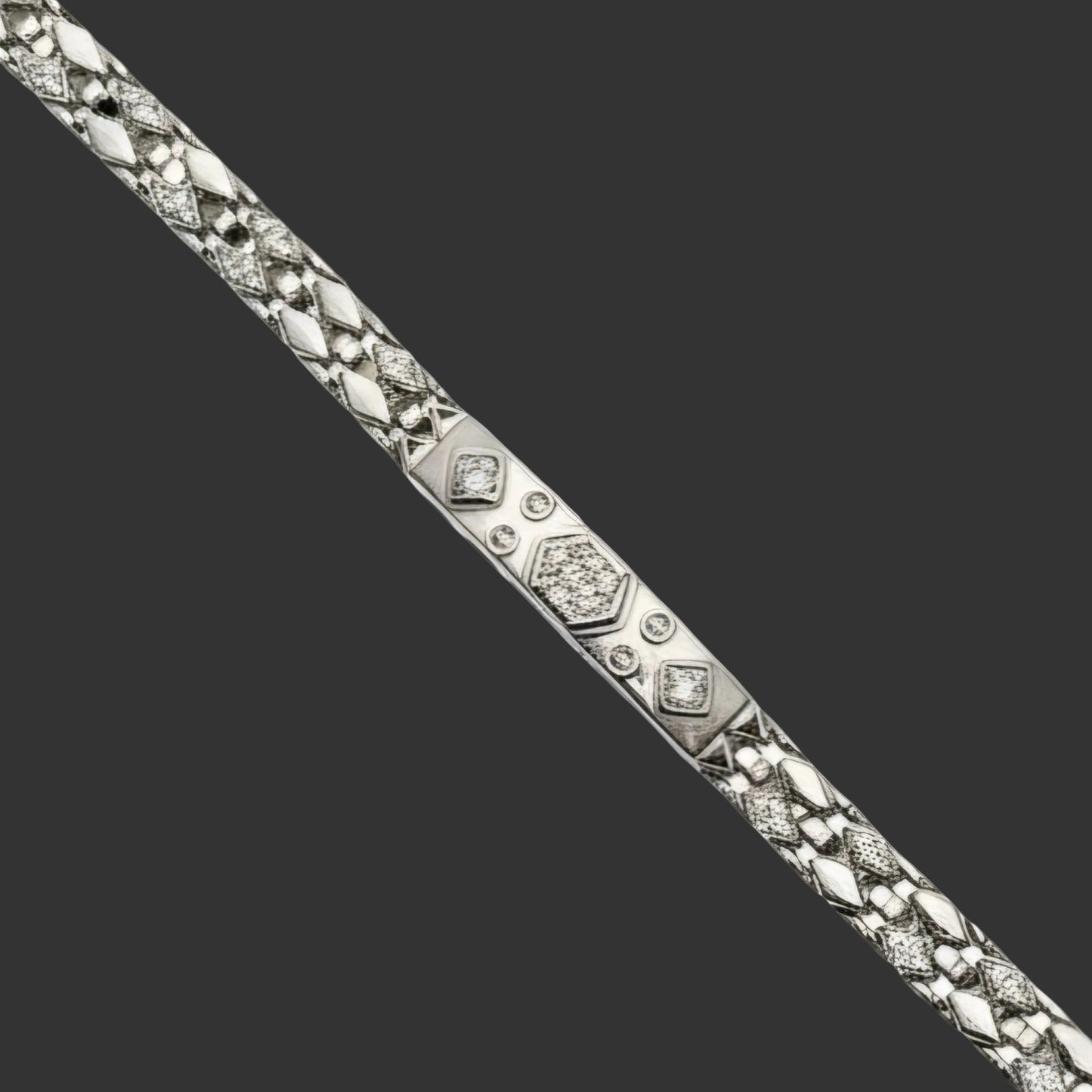 Silver bracelet with diamond accents on a white background