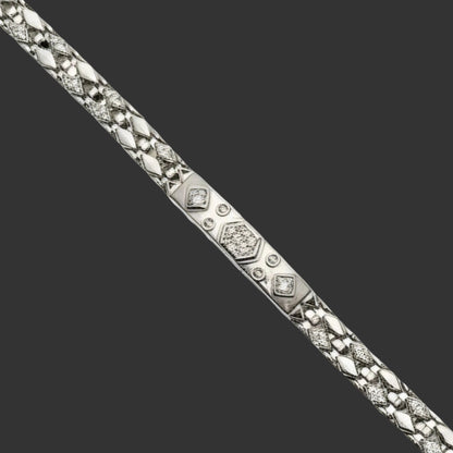 Silver bracelet with diamond accents on a white background