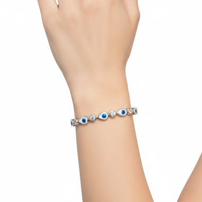 Bracelet with blue and silver beads on a wrist against a white background